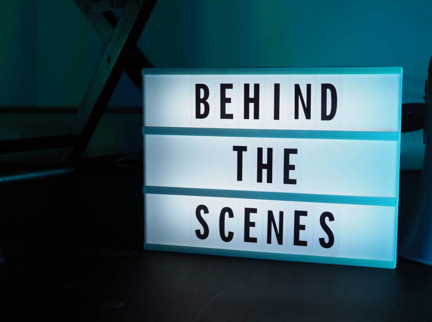 Behind the Scenes written on a LED screen