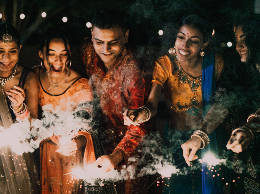 A group of 5 celebrating diwali with sparklers