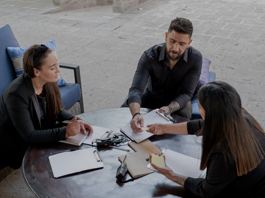 A couple sitting with an event planner discussing their wedding