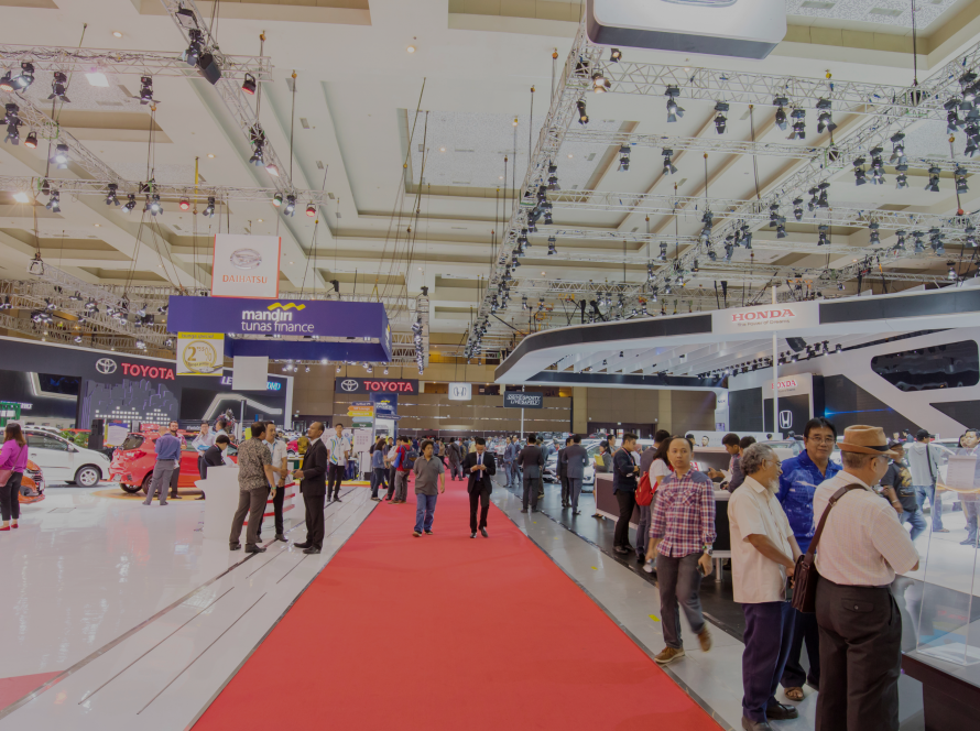 A photo of Exhibition with people walking around checking out the items